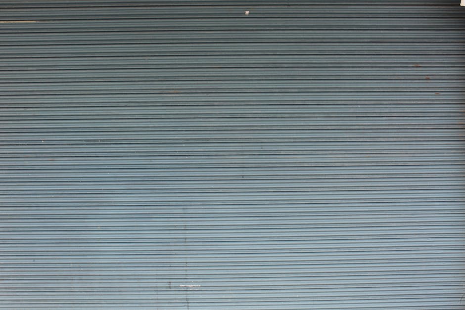 Industrial gray metal shutter door with horizontal lines creating a textured effect. Perfect for backgrounds.